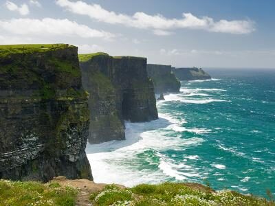 Stunning Cliffs of Moher view with rugged cliffs and turquoise waves, perfect for a scenic coastal getaway.