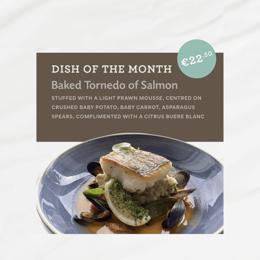 A plated baked torpedo of salmon with prawn mousse, baby potatoes, carrots, asparagus, and mussels, garnished with citrus buere blanc sauce. Price: €22.50.