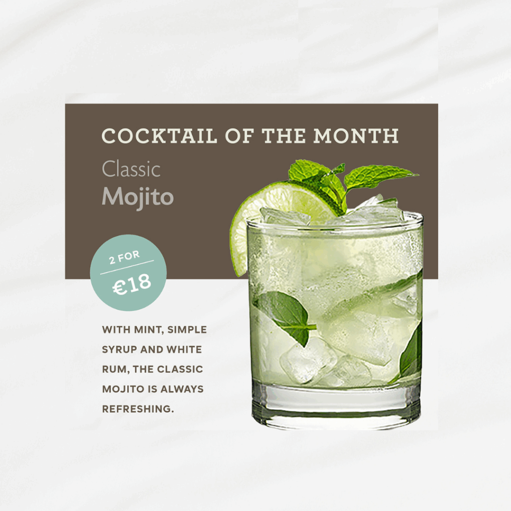A glass of mojito with lime and mint is displayed next to a sign reading 