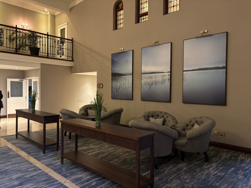 Elegant hotel lobby with plush seating, calming artwork, and stylish decor, offering a warm and welcoming atmosphere.