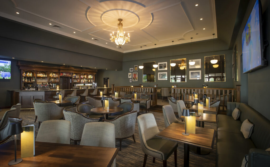 Elegant hotel bar with plush seating, warm lighting, and modern decor for a cosy dining and social experience.