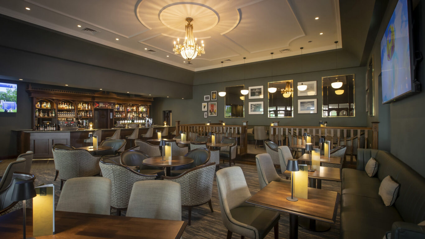 Elegant hotel bar with plush seating, warm lighting, and modern decor for a cosy dining and social experience.