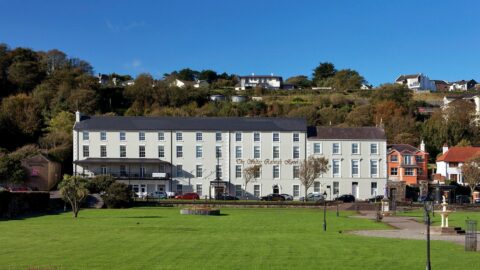 Elegant countryside hotel with lush gardens, scenic views, spacious parking, ideal for a relaxing getaway.